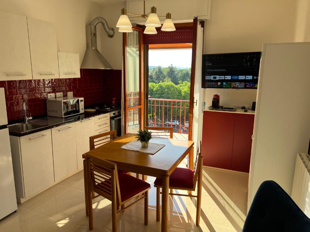 a kitchen with a table and chairs and a window at Dario's House 2 in Scandicci