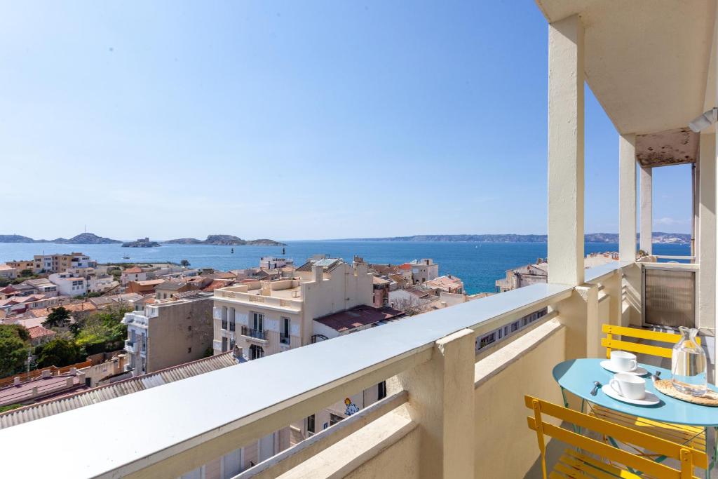 a balcony with a view of the ocean and buildings at HORIZON MER - Splendide vue Mer et îles in Marseille
