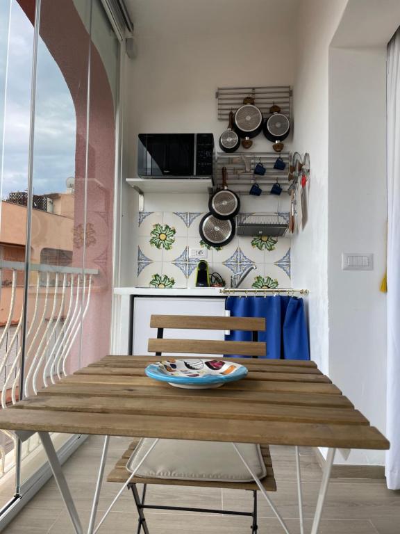 La finestra sul porto في بورتو إركولي: غرفة طعام مع طاولة خشبية في مطبخ