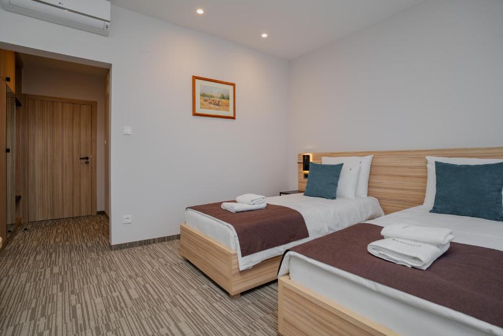 Postel nebo postele na pokoji v ubytování Maestro - Rooms & Restaurant