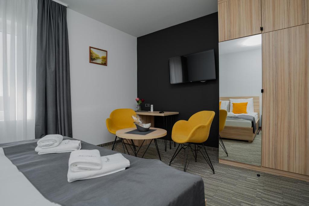 Postel nebo postele na pokoji v ubytování Maestro - Rooms & Restaurant