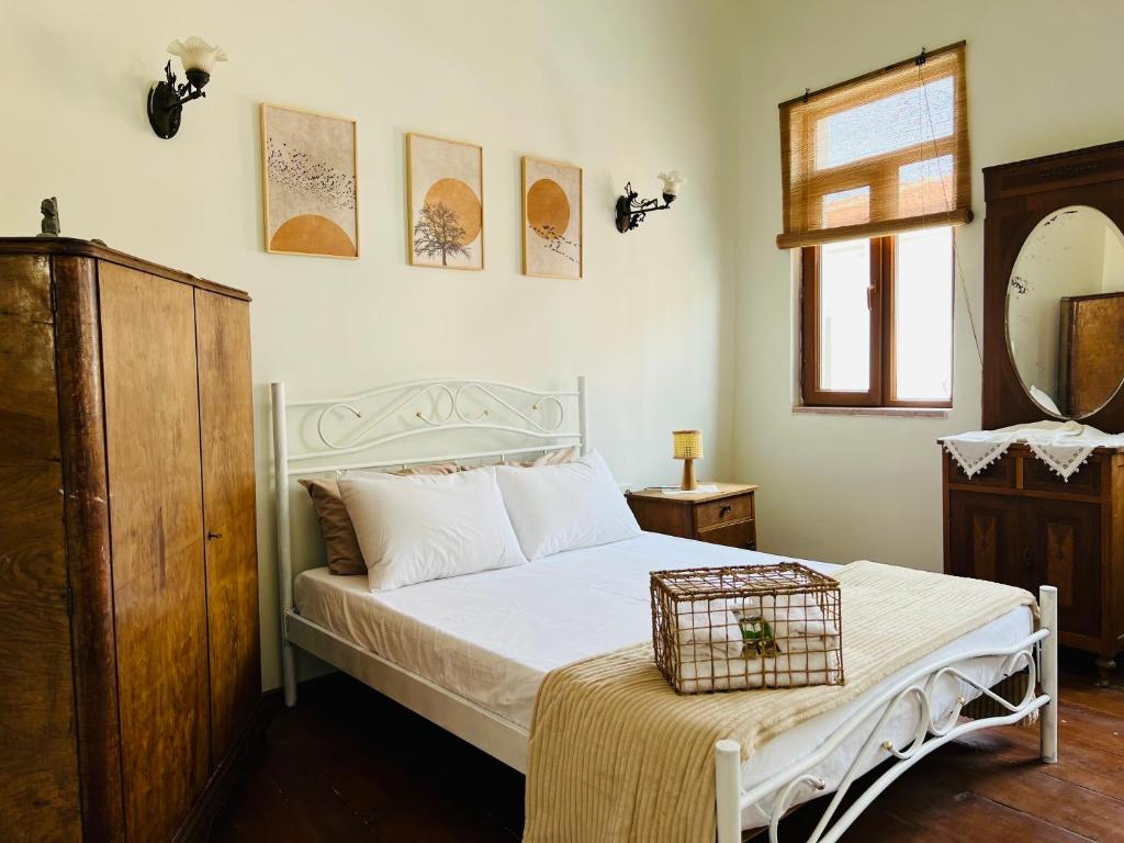 a bedroom with a white bed and a mirror at Hygge Ayvalık in Ayvalık