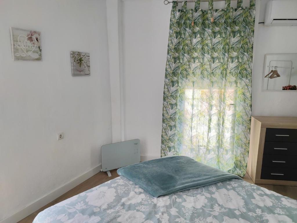 Łóżko lub łóżka w pokoju w obiekcie Encantadora Casa con Patio