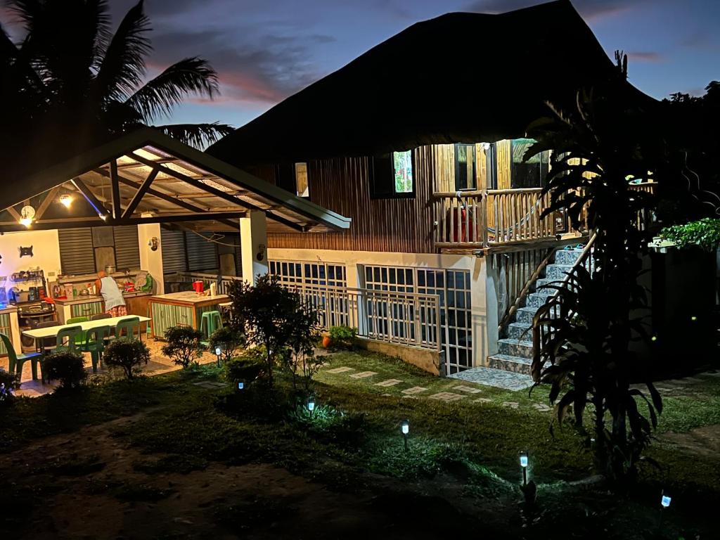 a house with a patio and a porch at night at Bahay Kubo ZaiLaiH in Silang