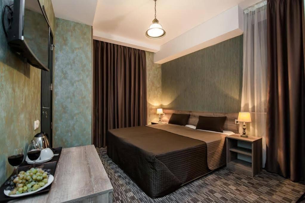 a hotel room with a bed and a plate of food at Old Side Boutique Hotel in Tbilisi City