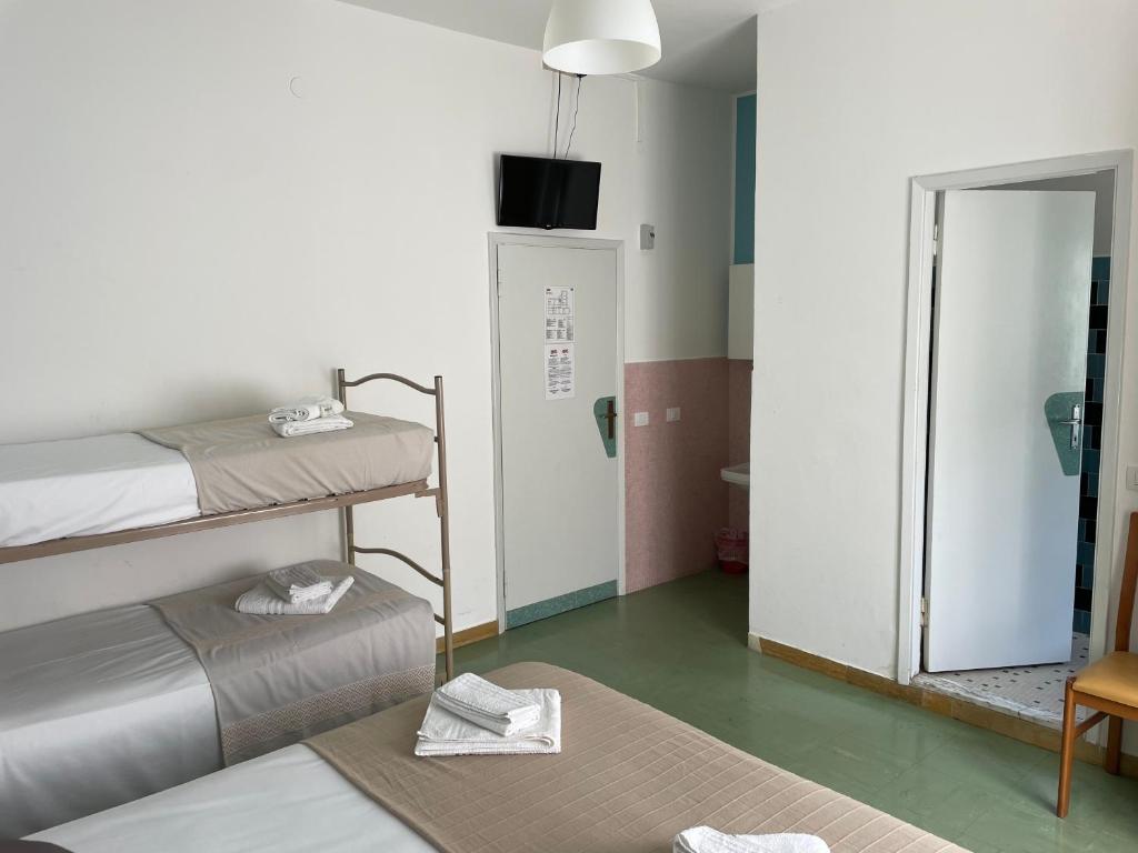 Postel nebo postele na pokoji v ubytování Hotel Aloha