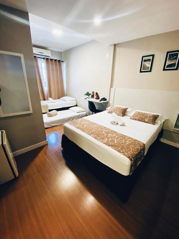 Postel nebo postele na pokoji v ubytování Hotel Lorimar