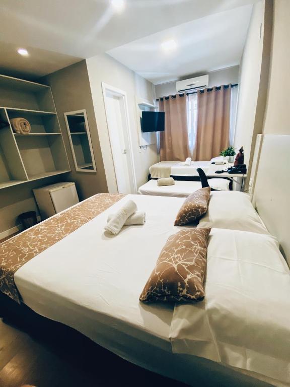Postel nebo postele na pokoji v ubytování Hotel Lorimar