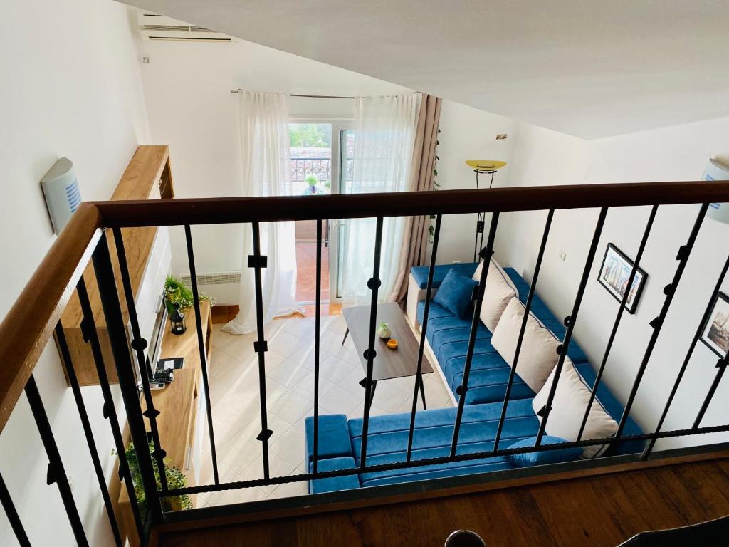 a staircase with blue seats in a living room at Apartment Blue in Sveti Stefan