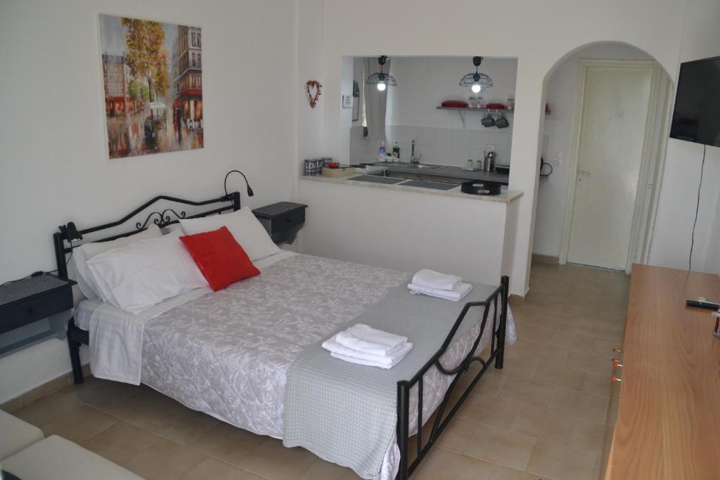 a small bedroom with a bed and a kitchen at A Place to Relax 2 in Nisakion