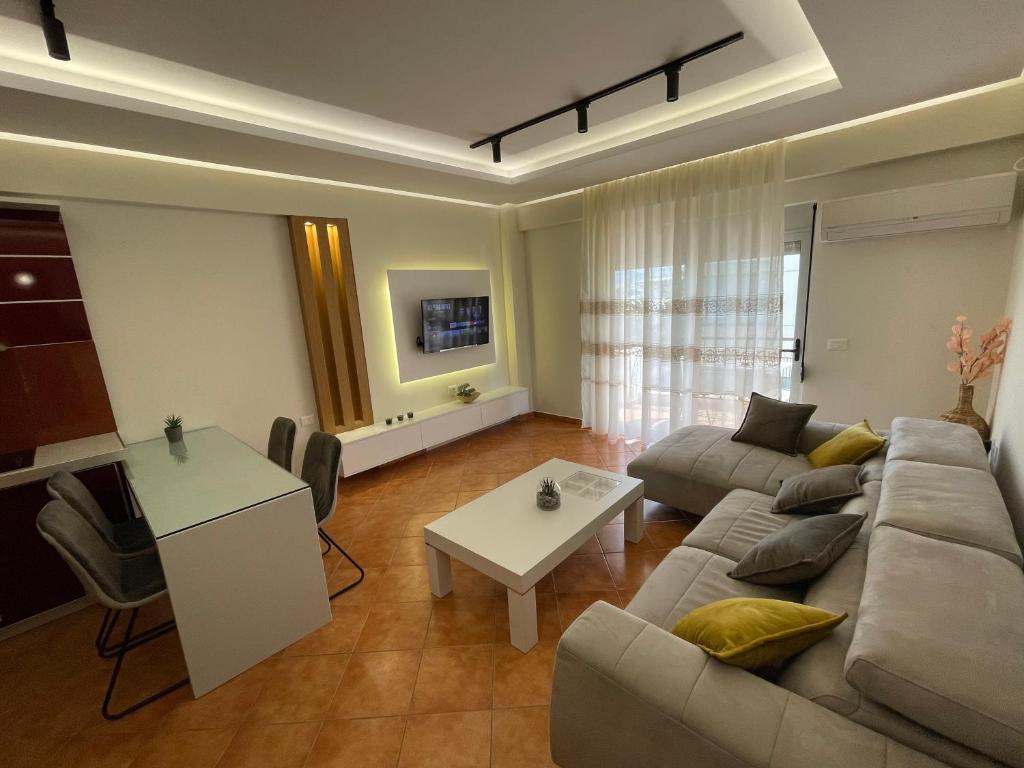 a living room with a couch and a table at Saranda Central Apartment in Sarandë