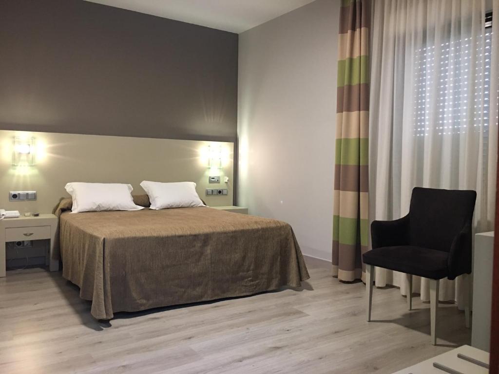 Postel nebo postele na pokoji v ubytování Hotel Puente de La Toja