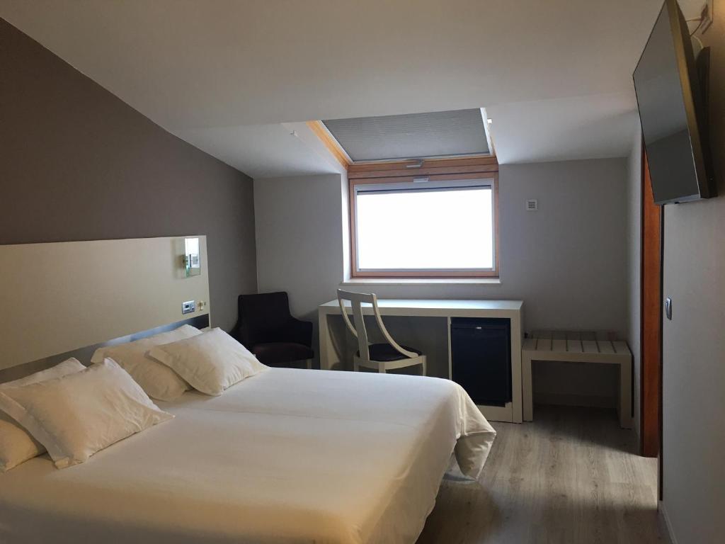 Postel nebo postele na pokoji v ubytování Hotel Puente de La Toja