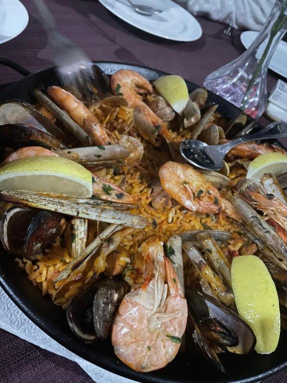 a plate of food with seafood and rice on a table at Auberge Oualidia Dream in Oualidia