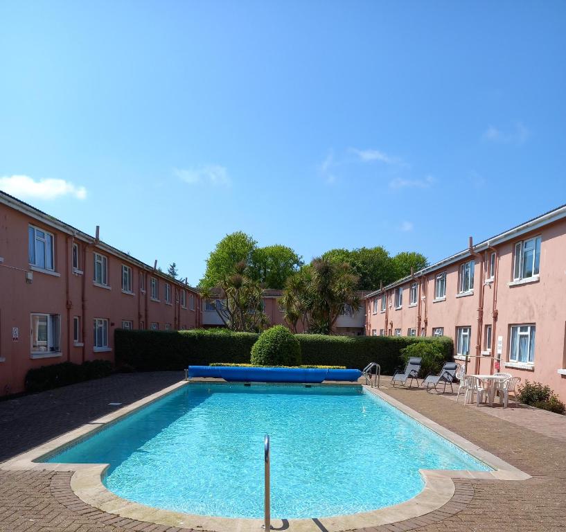 une piscine au milieu d'une cour dans l'établissement 50 New Esplanade Court, à Paignton