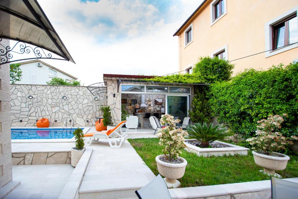 a backyard with a pool and a house at Mejić Apartments in Kotor