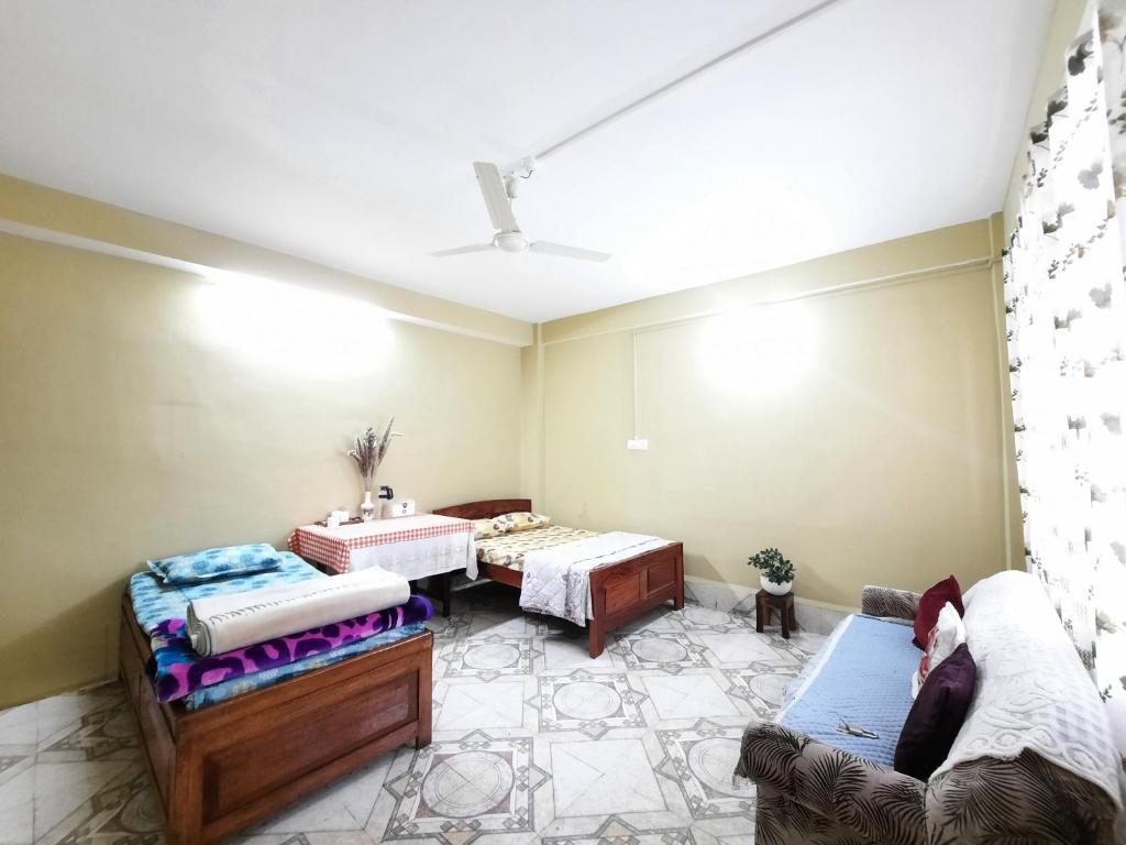 Postel nebo postele na pokoji v ubytování Kalimpong Sunrise-Inn Homestay