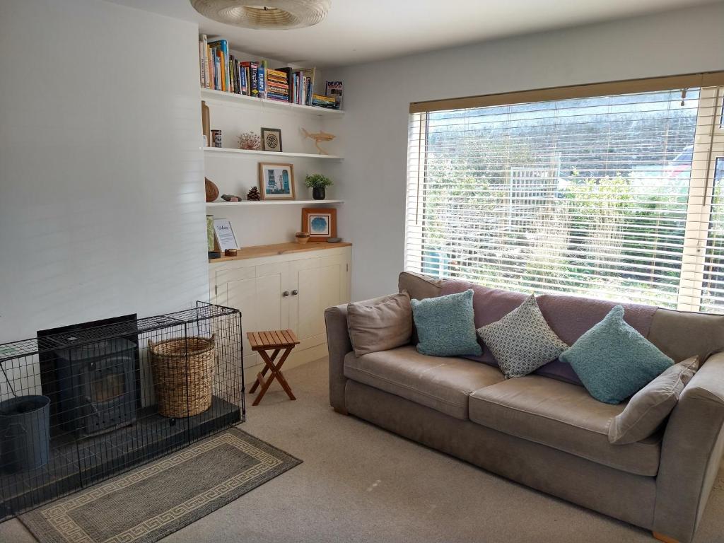 a living room with a couch and a fireplace at Toppers Bright Seaview Family or Couple Home Devon Westward Ho! in Bideford