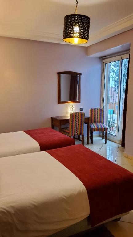 Postel nebo postele na pokoji v ubytování Hôtel Amouday