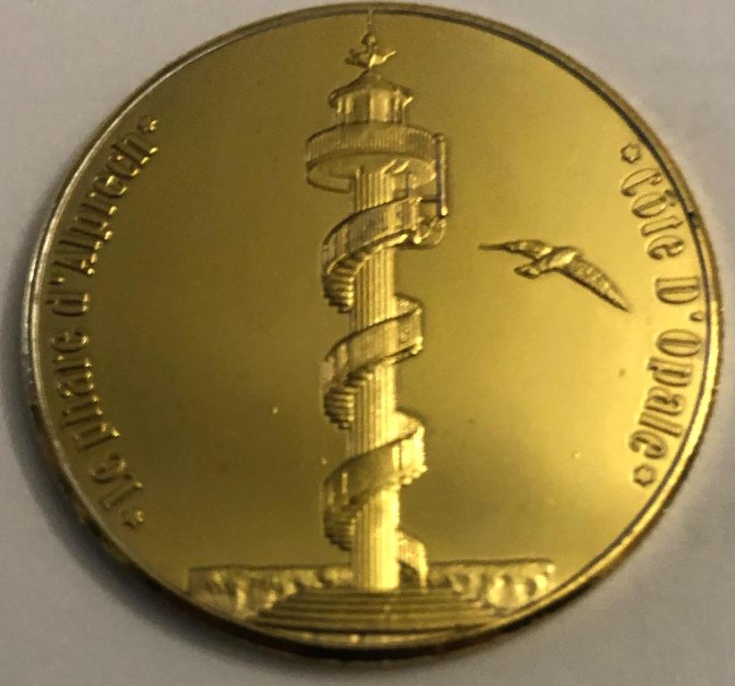 a gold dollar coin with a depiction of a lighthouse at Appartement à Le Portel in Le Portel