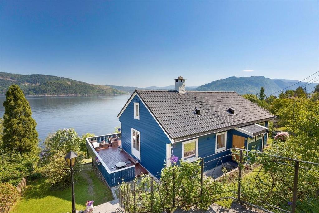 an aerial view of a blue house on the water at Bergen sunrise Apartment - self check in - Free Parking in Bergen