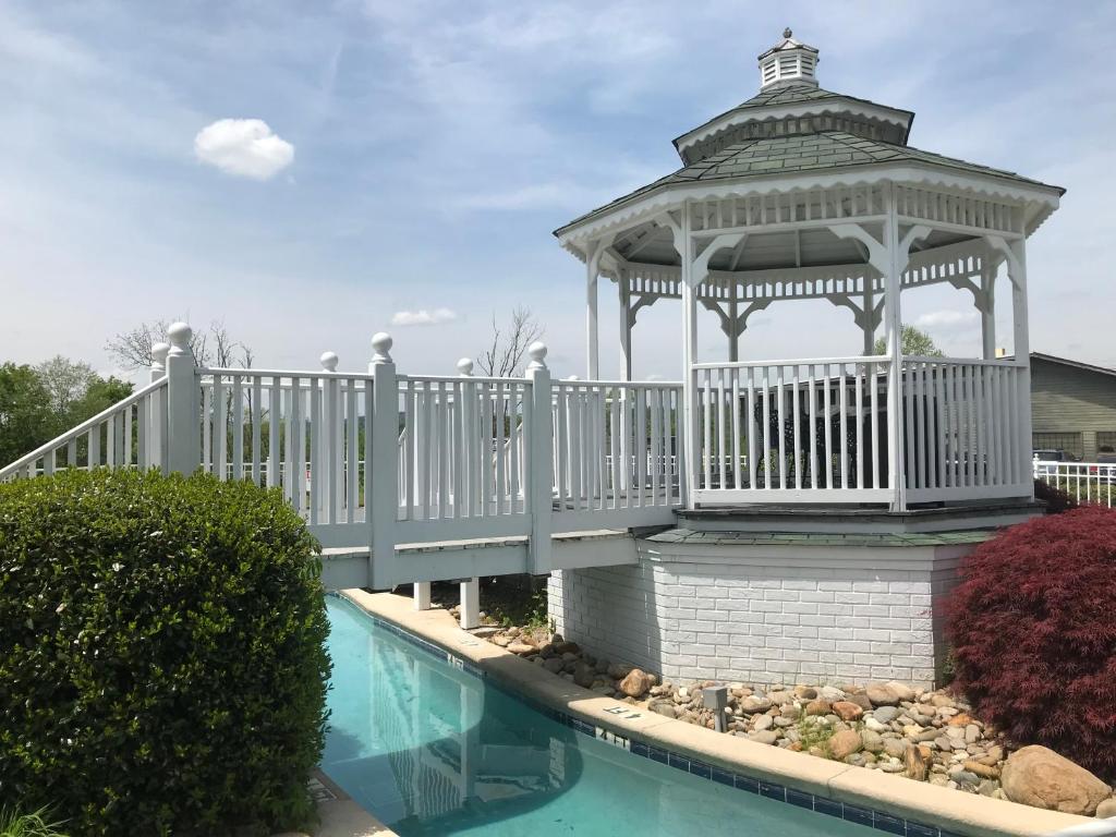 a gazebo next to a swimming pool at Clarion Inn Willow River in Sevierville