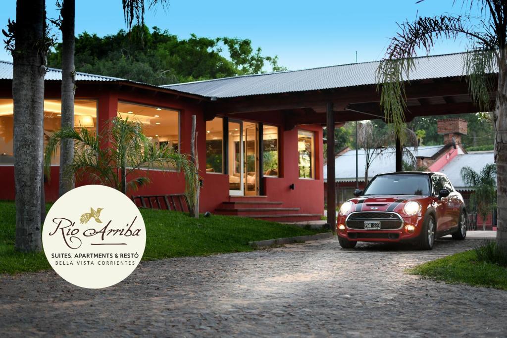 a car parked in front of a house at Río Arriba Suites & Apartments & Restó in Bella Vista