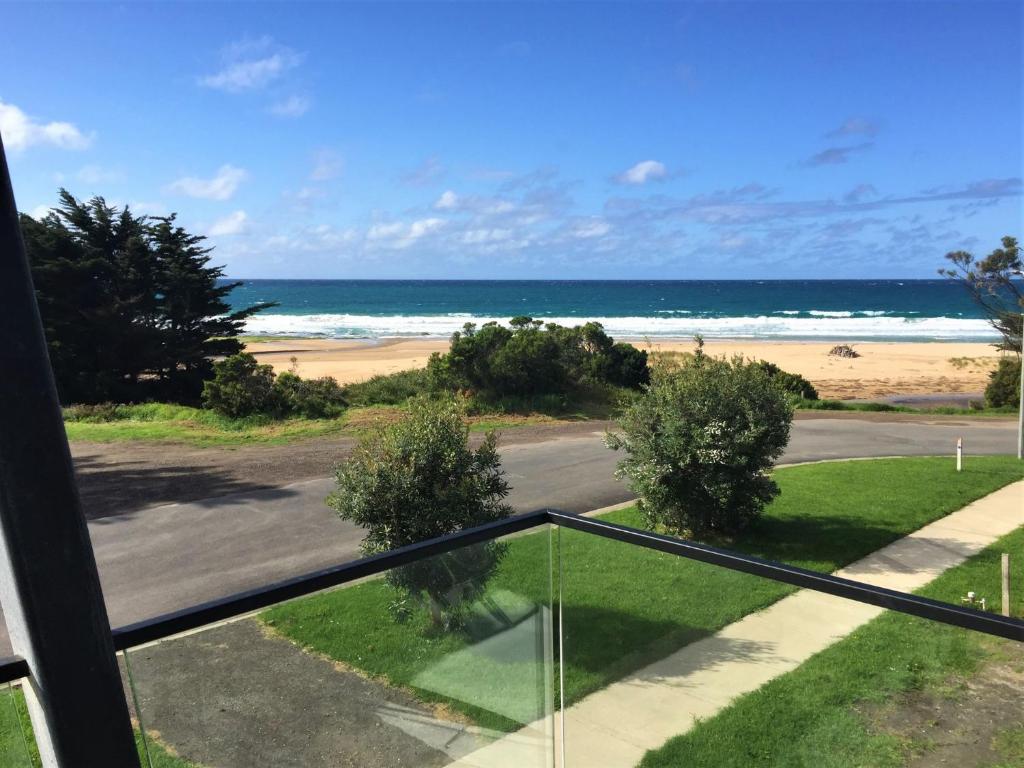 a view of the beach from the balcony of a house at Tadasana in Apollo Bay