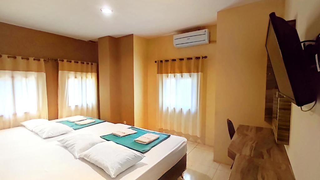 Postel nebo postele na pokoji v ubytování Hotel Syariah Larismanis