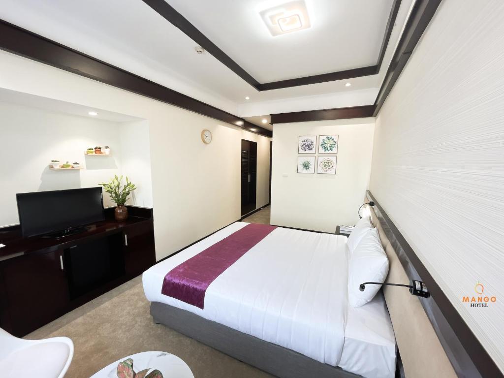 Postel nebo postele na pokoji v ubytování Mango Hotel - Ha Noi Railway station