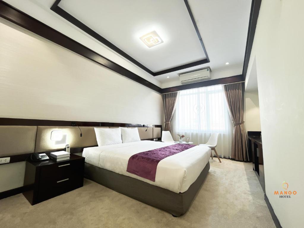 Postel nebo postele na pokoji v ubytování Mango Hotel - Ha Noi Railway station