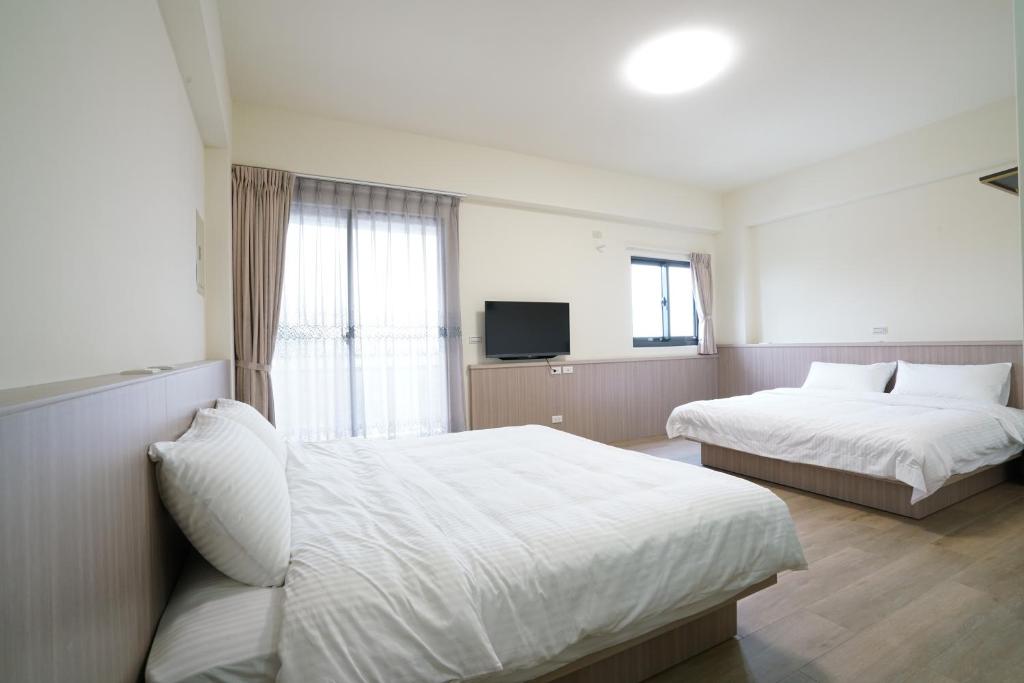 Postel nebo postele na pokoji v ubytování 享悅二館電梯民宿