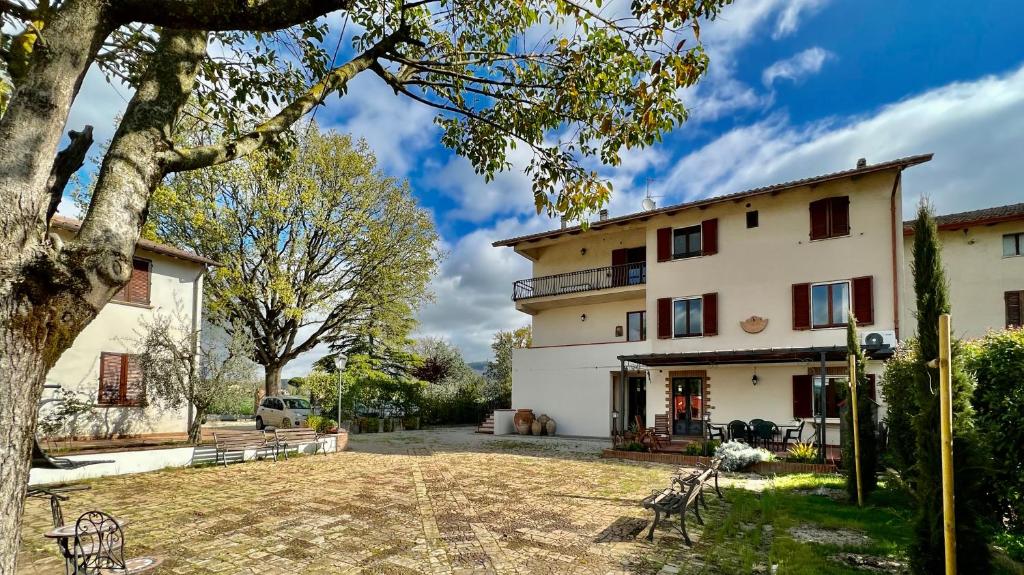 a large house with a tree in front of it at Il Quercione Agriturismo in Rivotorto