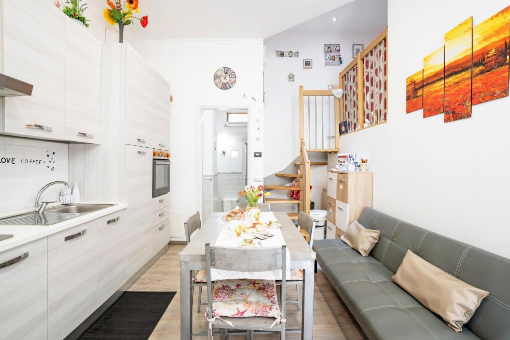 a kitchen with a couch and a table in a room at Casa Vacanze Francesca in La Spezia