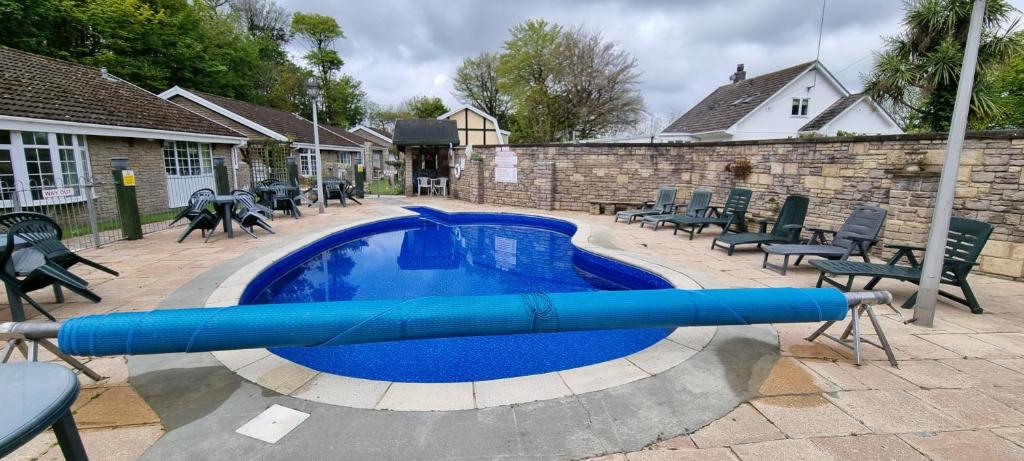 a swimming pool with a blue tube in it at Heated Swimming Pool Looe Polperro Cornwall Holiday Home in Looe