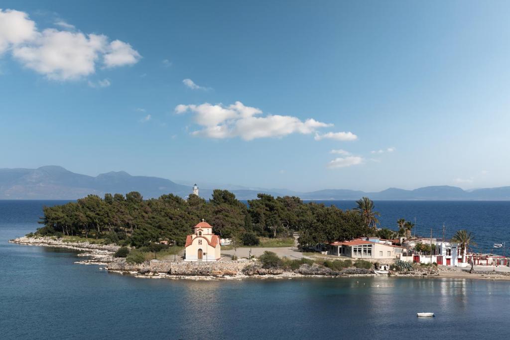 a small island with a church in the middle of the water at The Olive Yard in Gythio
