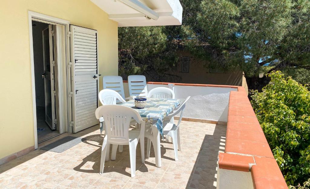 a table and chairs sitting on a patio at Santu Juanne -Ammentos Posada- a due passi dalla spiaggia in San Giovanni