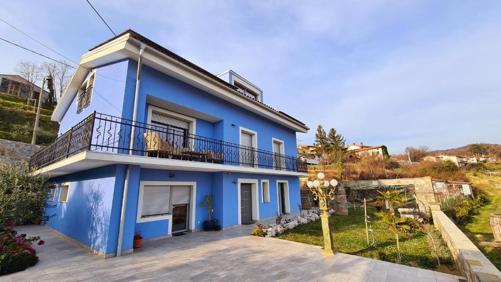 een blauw huis met een balkon bij Villa Azul in Kojsko