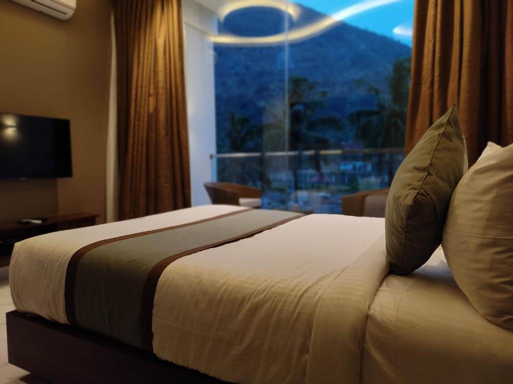 a bed in a hotel room with a window at SILVER CLOUD in Nandigunda