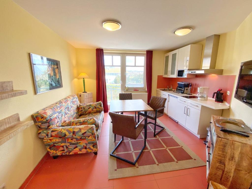 uma sala de estar com uma mesa e uma cozinha em Appartements am Rondell Neddesitz, Appartement 305 em Neddesitz