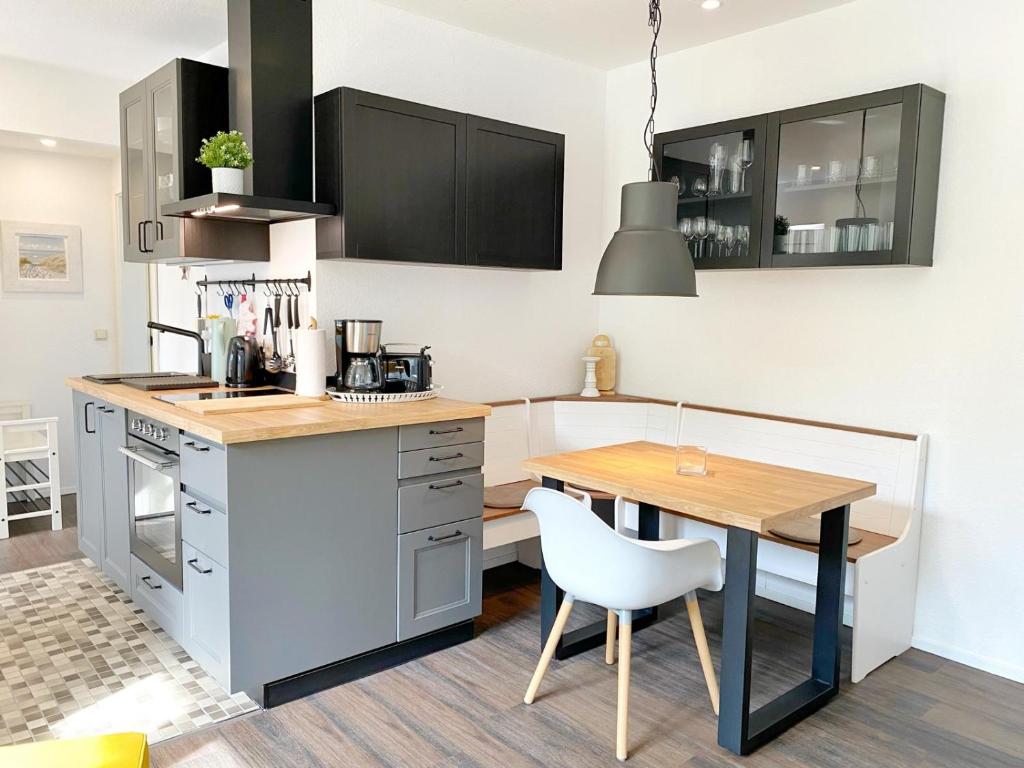 a kitchen with a table and a dining room at Gross Stresow Ferienwohnung Vilm E in Groß Stresow