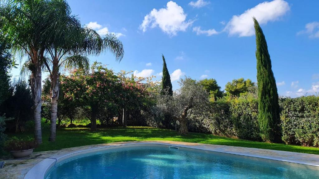 una piscina en un patio con árboles en Villa Dammusello, en Marsala