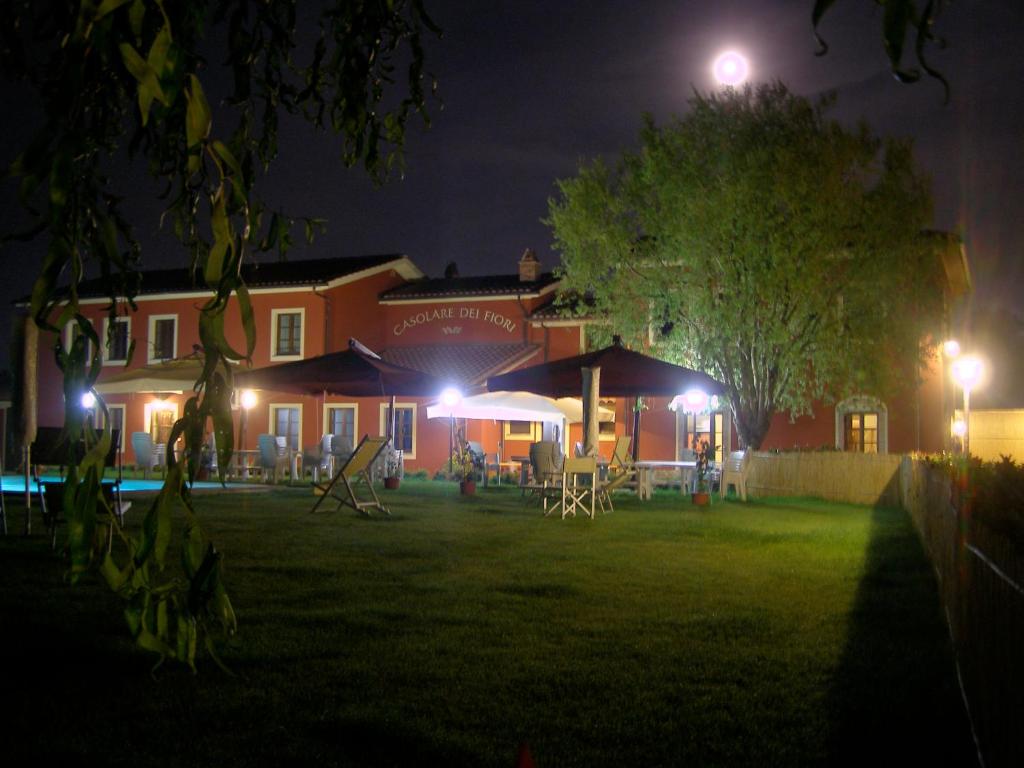 a house with a yard at night with lights at Room in Holiday house - Green Ortensia - Amazing apartment in Farmhouse in Chiesina Uzzanese