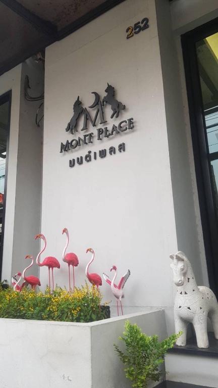 a sign on the side of a building with pink flamingos at Mont Place Donmuang in Ban Don Muang (1)