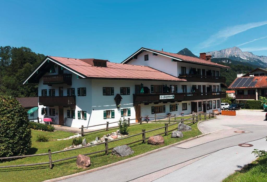 a large white building with a red roof at Hotel Binderhäusl in Berchtesgaden