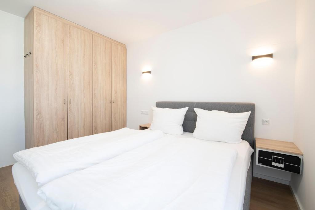 Postel nebo postele na pokoji v ubytování Smart & Stay Aparthotel Saarlouis Lisdorf - Self-Check-In - Free Parking