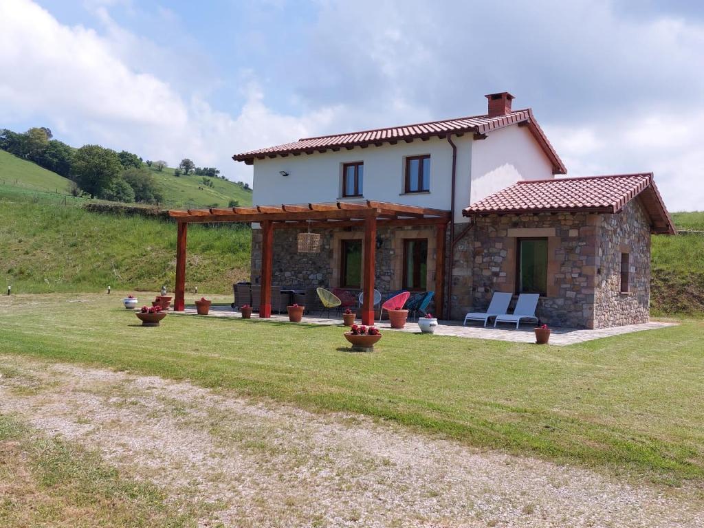 a small stone house on a grass field at Miraverde Liérganes in Liérganes