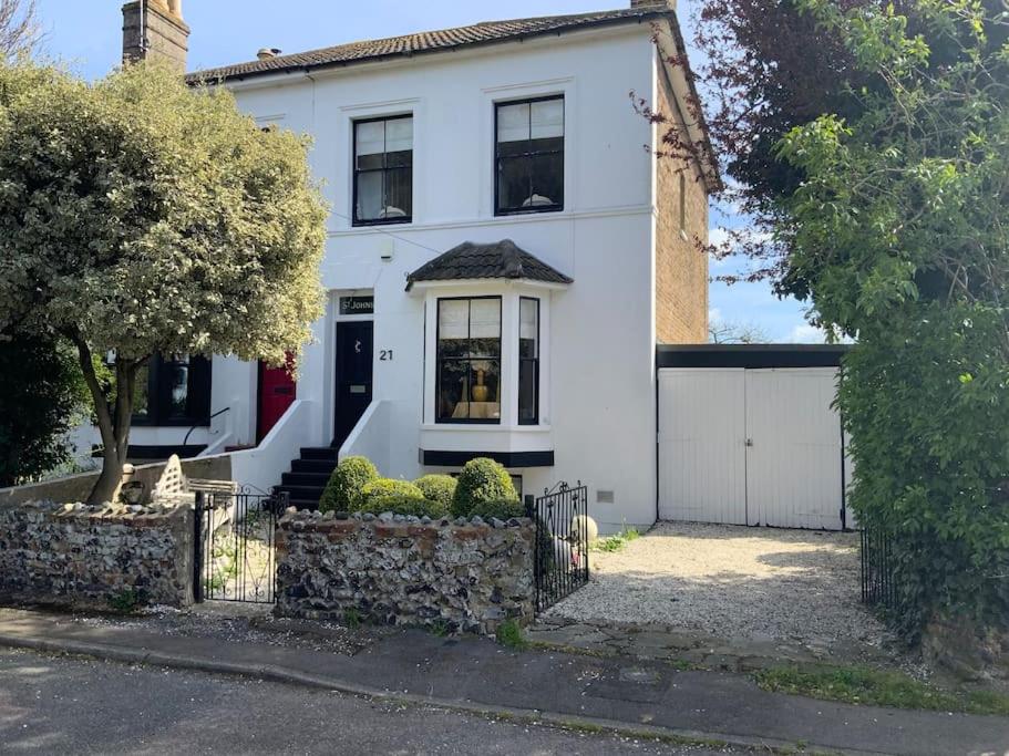 a white house with a fence in front of it at Entire Edwardian Style Luxury Home in Broadstairs