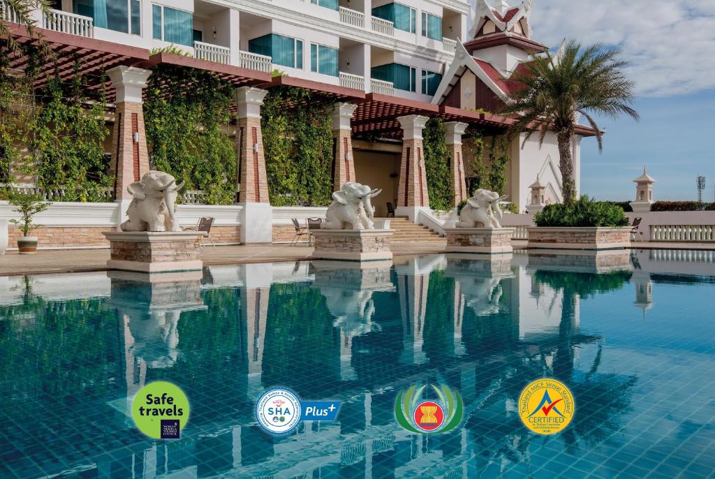 a swimming pool in front of a resort at Grand Pacific Sovereign Resort & Spa in Cha Am