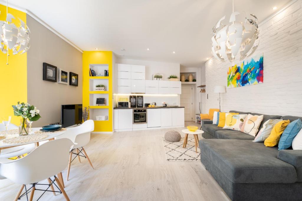 布達佩斯的住宿－BpR Lavish Suite in Budapest Downtown，客厅配有灰色沙发和黄色调